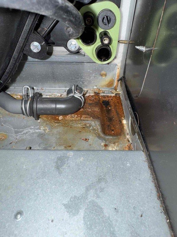 Completed routine maintenance on Payne furnace system in residential basement. Identified significant rust and corrosion on interior components, particularly around the heat exchanger connection ports. Documented water heater condition (Bradford White model 100) for future reference as it appears to be approaching end of service life.