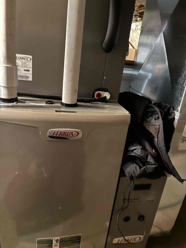 Performed routine maintenance tune-up on a Lennox HVAC system located in the utility area. Conducted electrical diagnostics using a Fieldpiece SC680 multimeter, which showed a reading of 5684 during component testing. Inspected all connections, ductwork, and PVC venting for proper installation and functionality, confirming system is operating within normal parameters.