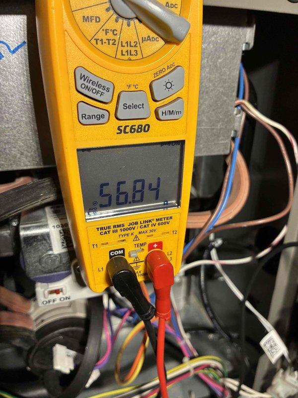 Performed routine maintenance tune-up on a Lennox HVAC system located in the utility area. Conducted electrical diagnostics using a Fieldpiece SC680 multimeter, which showed a reading of 5684 during component testing. Inspected all connections, ductwork, and PVC venting for proper installation and functionality, confirming system is operating within normal parameters.
