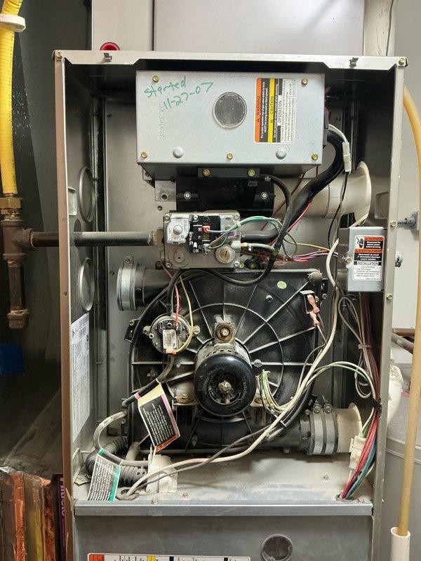 Conducted comprehensive inspection of aging Carrier HVAC system. Interior assessment revealed deteriorated blower motor assembly with significant wear on control board (dated "5/20-07"). Recommended complete system replacement due to advanced equipment age, inefficient operation, and potential for imminent failure. New high-efficiency unit will provide improved reliability and energy performance.