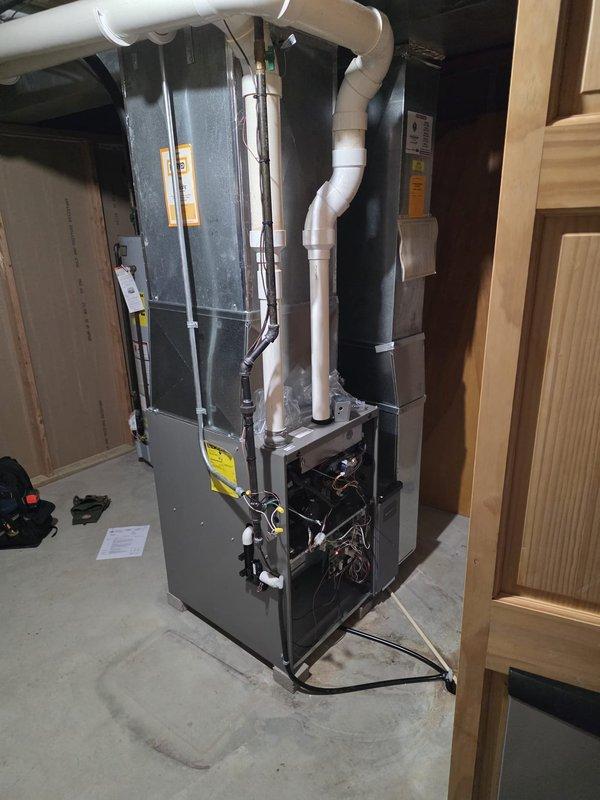 Successfully installed new furnace system with PVC venting in basement utility area. Connected to existing ductwork and installed new thermostat on interior wall. All systems tested and functioning properly at completion.