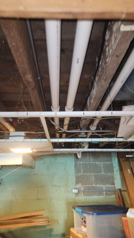 Completed installation of furnace unit in unfinished basement with proper routing of PVC exhaust and intake piping through ceiling joists. Ensured proper electrical connections at the circuit board, with wiring properly secured and organized using zip ties. Verified all control terminals and warning labels were intact for safe system operation.