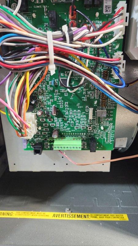 Completed installation of furnace unit in unfinished basement with proper routing of PVC exhaust and intake piping through ceiling joists. Ensured proper electrical connections at the circuit board, with wiring properly secured and organized using zip ties. Verified all control terminals and warning labels were intact for safe system operation.