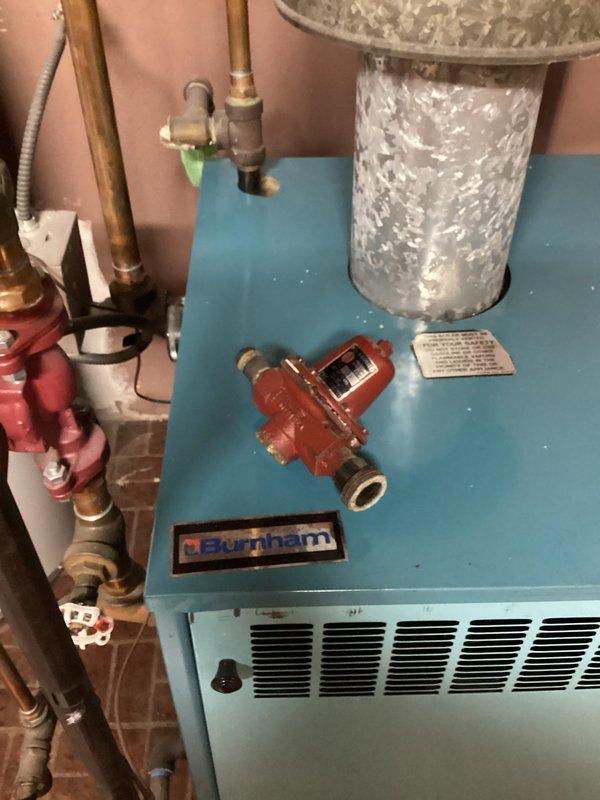 Diagnosed no heat issue on Burnham boiler system less than 10 years old. Inspected manual shutoff valves, pressure regulator, and copper piping configuration. Restored heating functionality by adjusting pressure settings and verifying proper operation of all system components.