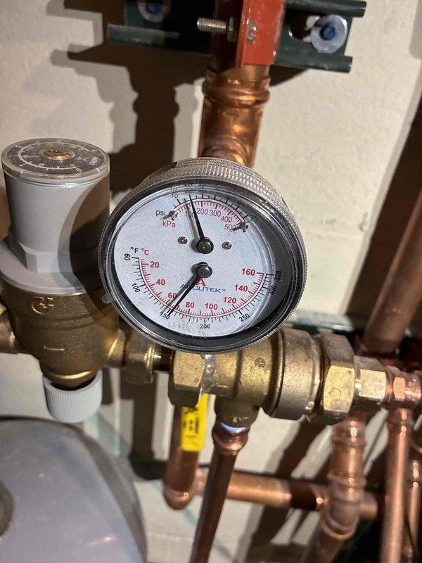 Performed inspection of boiler system, checking pressure/temperature readings on gauge. Verified proper operation of expansion tank and associated pressure relief components. All copper piping connections and brass valves appeared intact with no leaks detected.