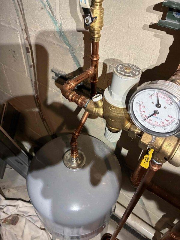 Performed inspection of boiler system, checking pressure/temperature readings on gauge. Verified proper operation of expansion tank and associated pressure relief components. All copper piping connections and brass valves appeared intact with no leaks detected.
