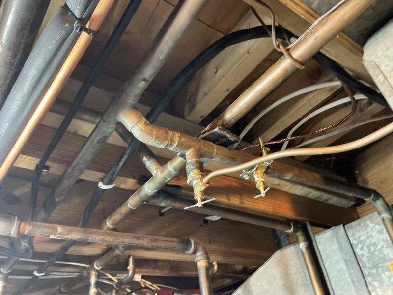 Conducted visual inspection of residential plumbing system, including copper pipe network throughout the basement/crawlspace and water heater installation dating from 12/18/13. Documented existing condition of plumbing infrastructure and identified potential IAQ concerns related to aging water heater and piping system for future remediation planning.