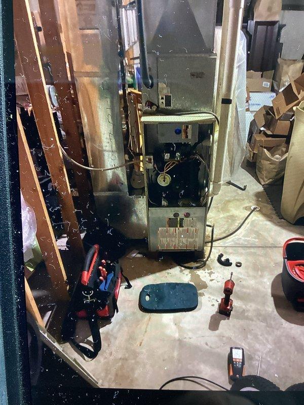 Conducted inspection and maintenance on older model furnace in unfinished utility room. Tools and diagnostic equipment were used to assess system condition. Customer's unit will require follow-up service due to age-related wear observed on internal components.