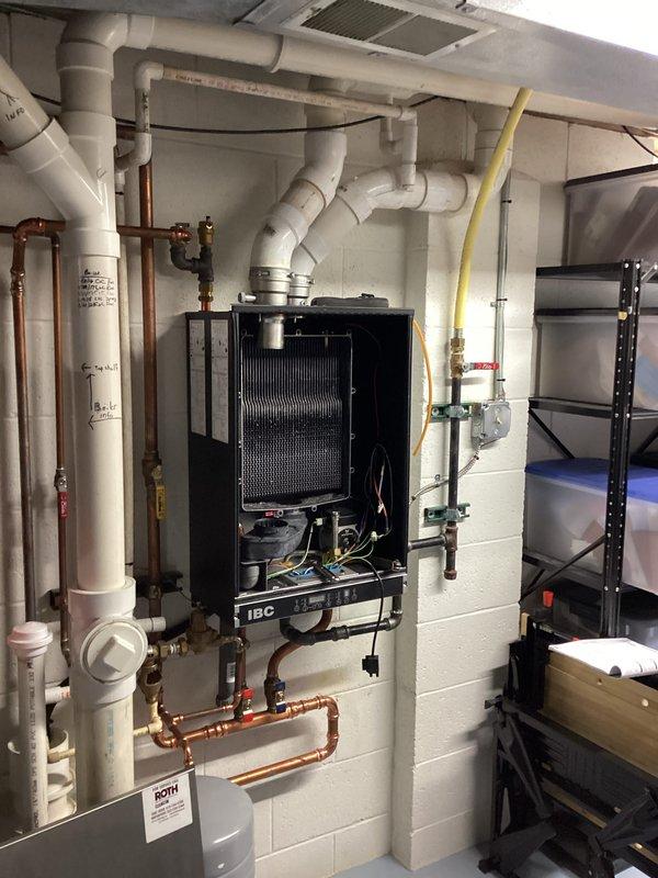 Completed tune-up maintenance on IBC boiler system. Inspected expansion tank, verified proper operation of pressure regulation components, and examined copper supply lines and PVC ventilation/drainage pipes for integrity. Visual inspection showed system in good working order with no immediate concerns.