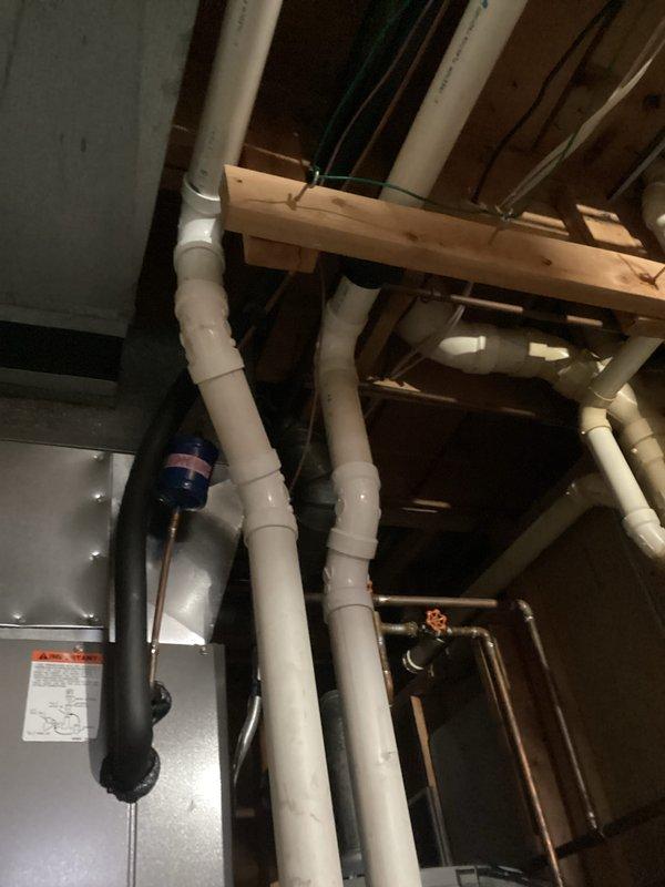 Performed comprehensive tune-up service on basement HVAC system, inspecting all visible plumbing connections and drainage pipes. Examined ceiling-mounted ductwork, checked light fixture operation, and verified proper insulation around mechanical components.