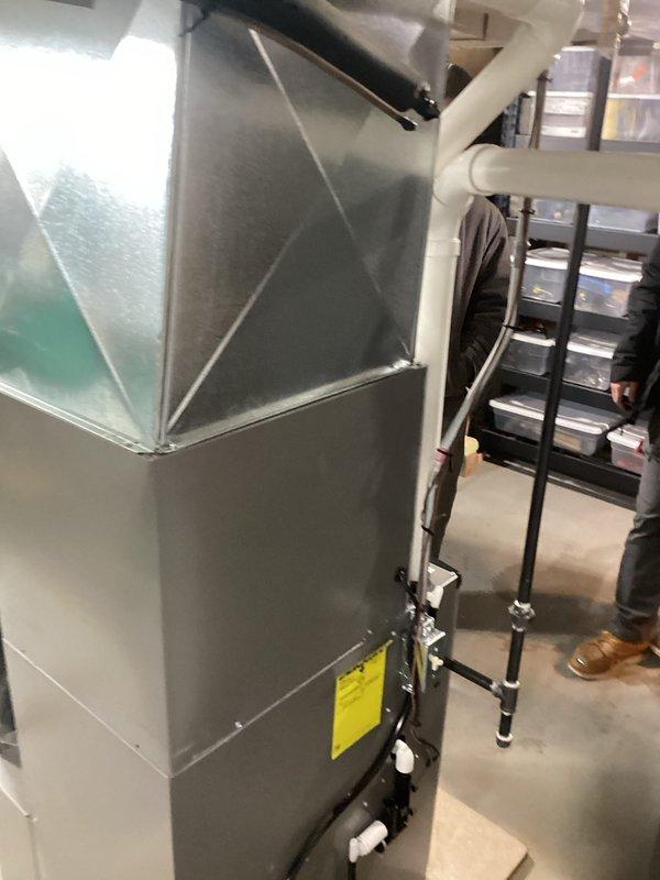 Successfully installed a complete HVAC system including a new furnace/air handler unit in the utility area. Properly connected all PVC venting and condensate drainage lines to manufacturer specifications, ensuring system functionality and code compliance. System was tested and is operating efficiently with all components properly secured and labeled.