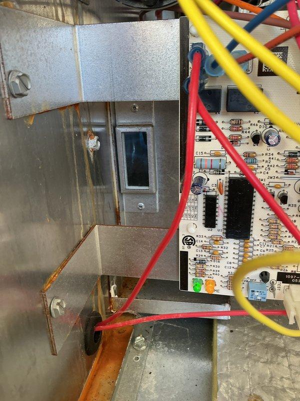 Conducted standard HVAC tune-up which included diagnostic testing with UEi meter showing temperature reading of 672. Inspected control board and wiring, confirming proper connection of control wires (red, yellow, and blue) to circuit board with LED indicators functioning normally. No issues detected with the system electronics or control components.