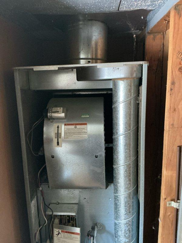 Conducted visual inspection of existing HVAC system located in utility closet. Older furnace unit showed normal wear with visible dust accumulation and minor corrosion on metal components. Inspected electrical connections and ductwork for replacement evaluation. Recommended full system replacement due to age-related deterioration and to improve efficiency.