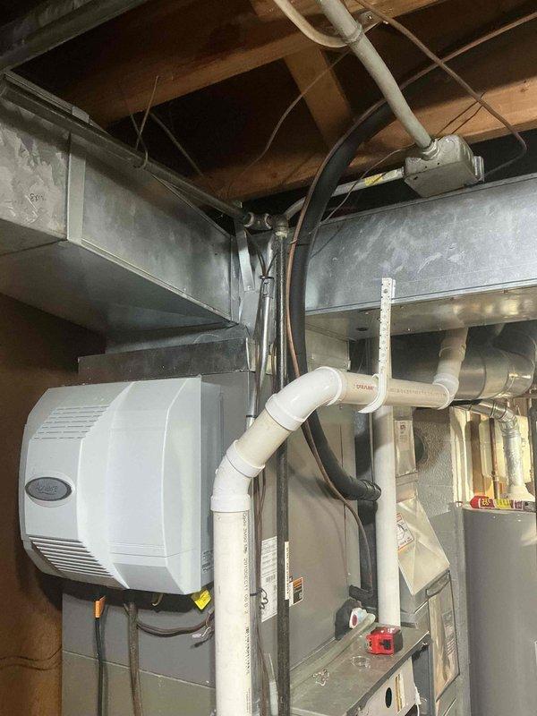 Installed new HVAC system including air handler/furnace unit with integrated control board and blower assembly. Mounted companion humidifier unit to improve indoor air quality. Connected complete system with appropriate PVC ventilation/drainage pipes and ensured proper routing of refrigerant lines and electrical components. All equipment properly secured and tested for optimal operation.