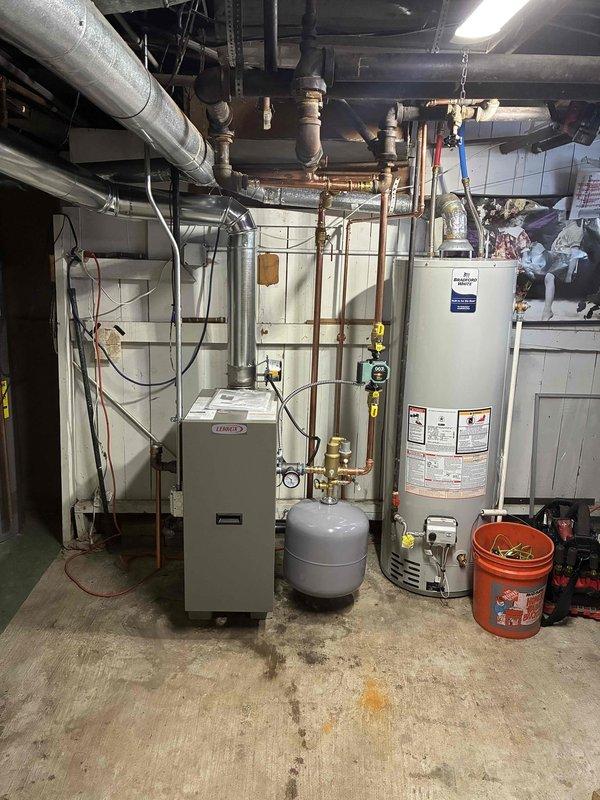 Completed installation of a new Lennox boiler system in basement utility area with integration to existing plumbing network. Successfully connected copper and galvanized piping, installed necessary expansion/pressure tank, and verified proper system operation with all gauges and controls functioning correctly.