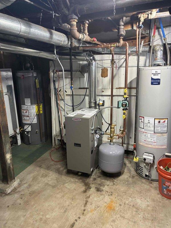 Completed installation of a new Lennox boiler system in basement utility area with integration to existing plumbing network. Successfully connected copper and galvanized piping, installed necessary expansion/pressure tank, and verified proper system operation with all gauges and controls functioning correctly.