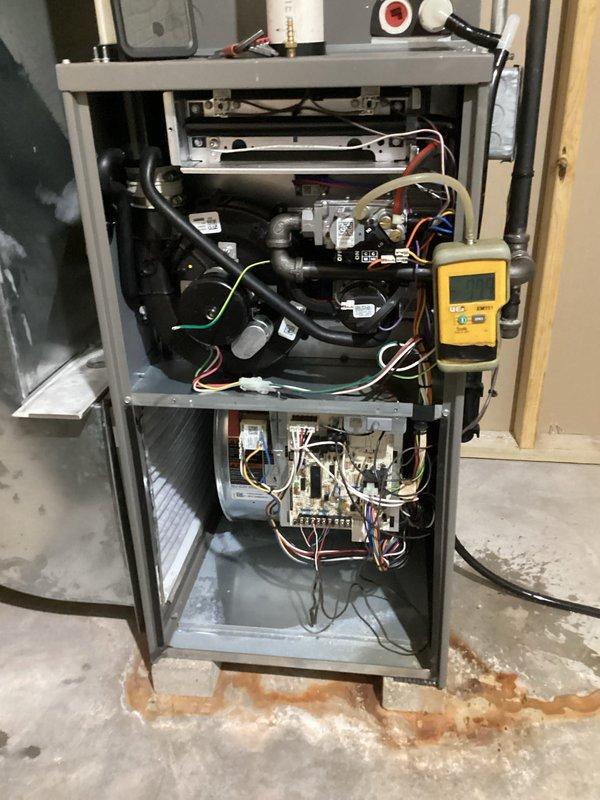 Performed routine tune-up of heating system including combustion analysis with Testo 310 II analyzer showing acceptable readings. Conducted inspection of furnace internals with front panel removed, checked electrical connections and verified proper operation of blower motor assembly. Connected diagnostic tool to evaluate system parameters and ensure all components functioning within specifications.