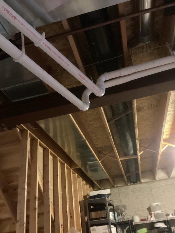Conducted preventive tune-up on HVAC system. Verified level installation of equipment using precision level tool and inspected plumbing connections in basement ceiling area, including PVC drain lines and associated ductwork. All components operating within normal parameters.
