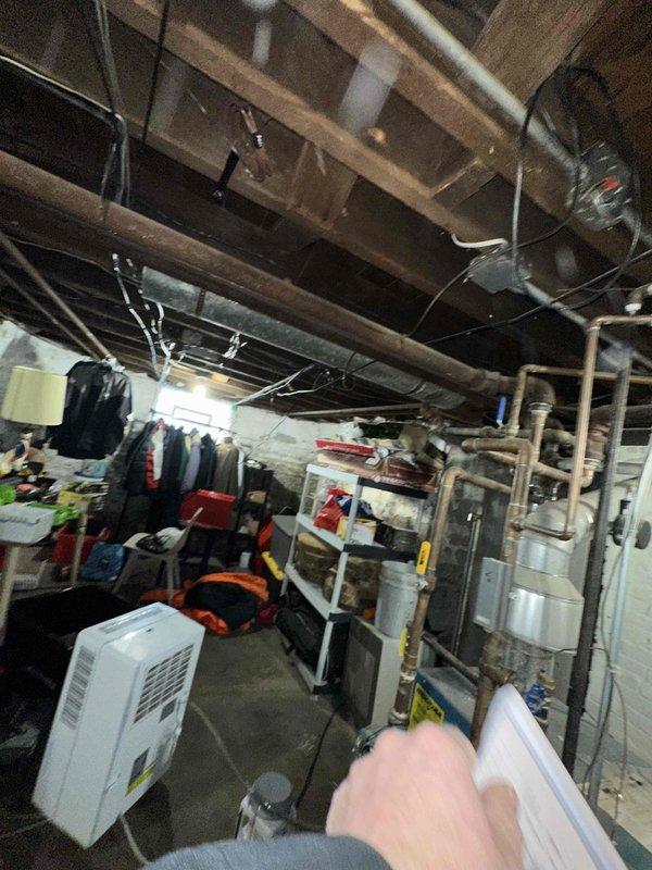 Conducted comprehensive inspection of existing HVAC system in unfinished basement area. Evaluated aging furnace unit showing signs of wear on internal components and wiring. Documented current installation conditions including ventilation configuration and potential replacement requirements for the complete system.