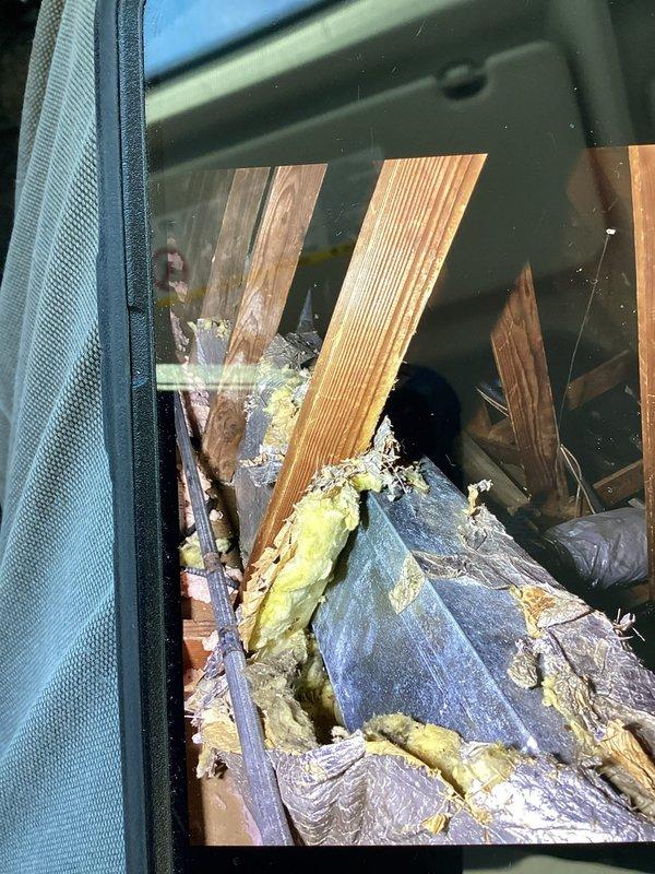 Conducted inspection of attic ductwork system, documented deteriorating insulation conditions with significant areas of exposed fiberglass and compromised vapor barrier. Identified potential airflow restrictions in the metal duct channels running between joists that could affect system efficiency.