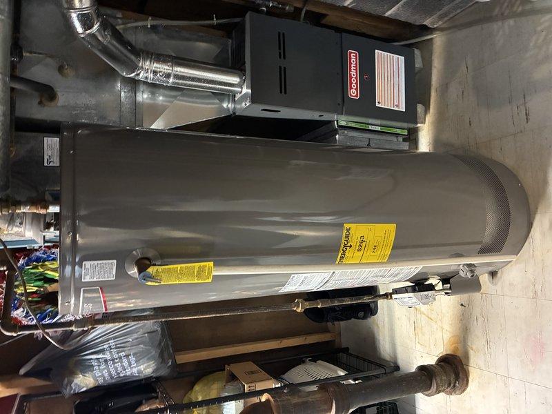 Performed visual inspection of tanked water heater system and adjacent Goodman HVAC unit. Equipment appears to be in normal operating condition with no signs of leaks, damage, or operational issues. All connections, piping, and ductwork confirmed intact and properly installed.