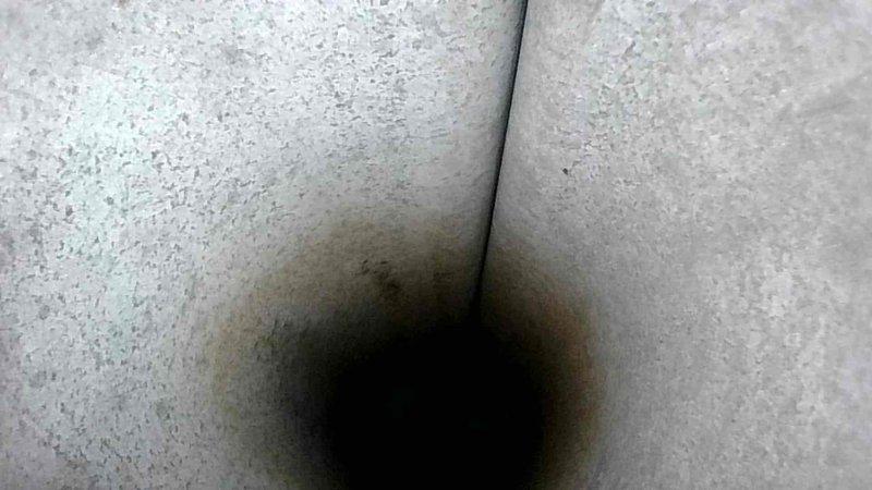 Performed routine HVAC tune-up service on existing furnace system. Inspected heat exchanger components and observed soot buildup in duct connections. Removed front panel to examine PVC exhaust pipe, draft inducer motor, control board, and wiring connections. All components were found in normal working condition with no signs of deterioration or leakage.