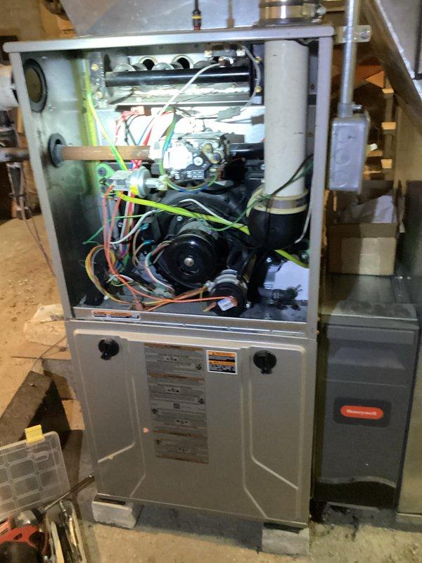 Diagnosed gas furnace with no heat issue. Inspection revealed an obstructed yellow condensate drain tube and accumulated debris in the internal components. Cleaned drainage system, removed debris from critical components, and verified proper operation of the blower motor and control board. System now functioning with normal heat output.