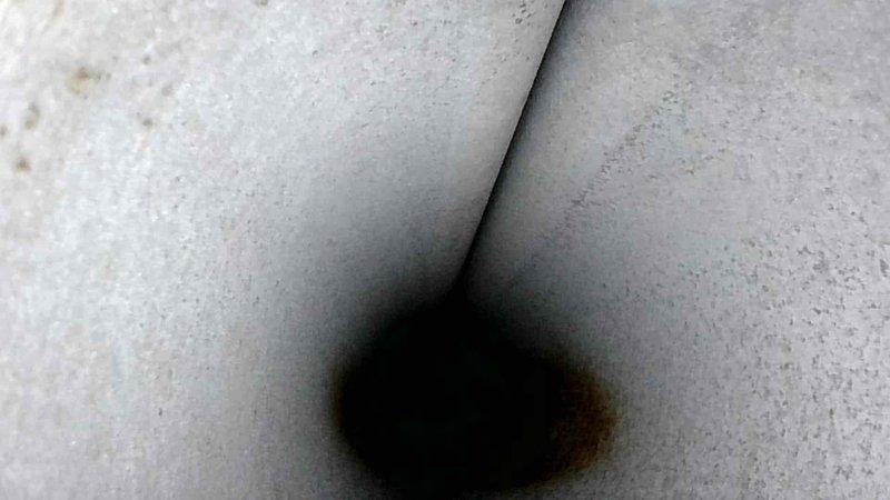 Performed standard tune-up service on HVAC system. Identified minor mold formation at corner junction of ductwork and measured supply air temperature at 25.8°F, which falls within normal operational parameters. Cleaned affected area and verified proper system function.