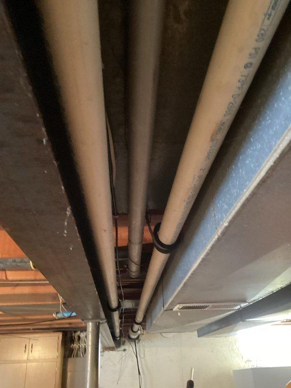 Performed standard HVAC tune-up inspection on residential furnace system, including removal of access panels for thorough examination of internal components, wiring connections, and circuit boards. Inspected surrounding utility connections and PVC ventilation pipes for proper installation and operation. All systems functioning within normal parameters with no issues identified.