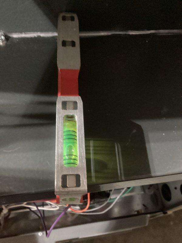 Performed preventative maintenance tune-up on HVAC system. Opened access panel to inspect electrical connections and wiring integrity across all components. Verified level installation of unit with bubble level tool to ensure proper operation and drainage.