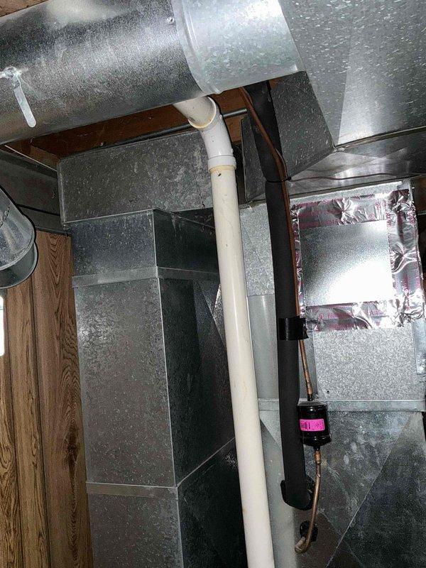 Completed installation of new HVAC ductwork system in residential utility area, including installation of galvanized sheet metal rectangular trunk line with proper transitions and junction boxes. All seams were properly sealed with metal tape, and the system was integrated with existing PVC ventilation pipe while ensuring proper connections to the air handler/plenum assembly.