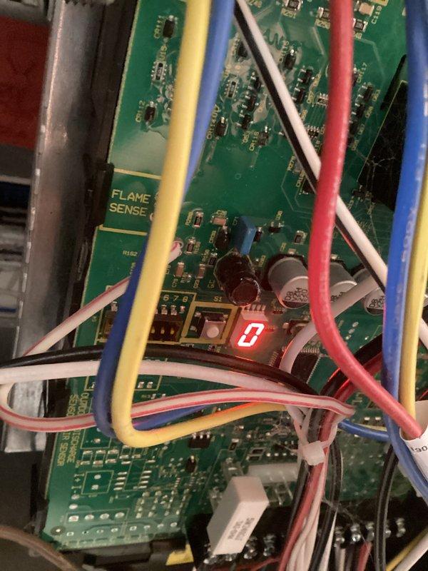 Conducted routine HVAC tune-up service including inspection of the flame sensor circuit board, which displayed a "0" reading indicating proper operation. Verified system leveling using carpenter's level, confirming equipment is properly balanced for optimal performance.