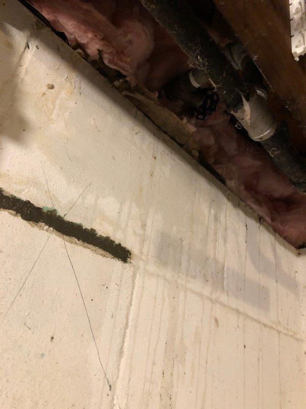 Responded to service call regarding frozen pipes. Inspected basement utility area showing signs of moisture damage where several pipes were affected. Found inadequate insulation around plumbing in structural areas with exposed fiberglass insulation and improper gaps around horizontal pipe runs. Thawed frozen pipes, checked for leaks around water heater connections, and installed additional pipe insulation to prevent future freezing issues.