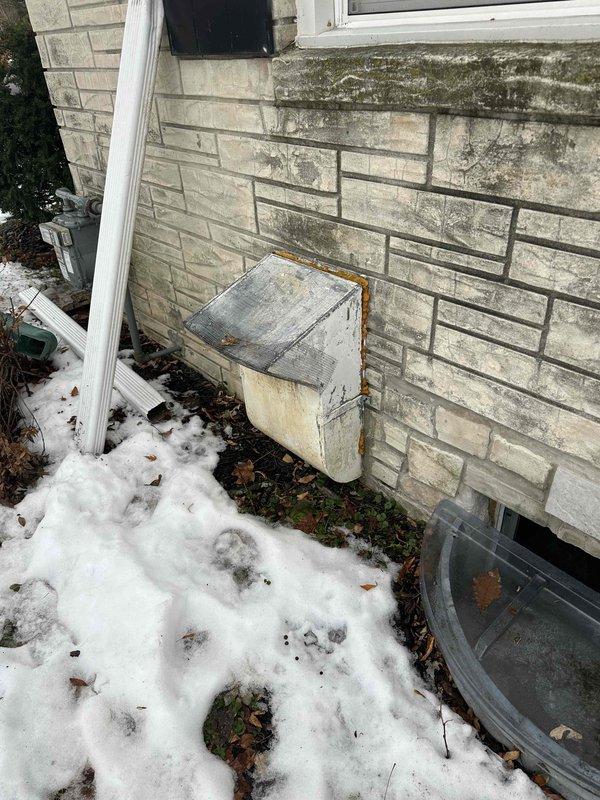 Conducted comprehensive inspection of aging HVAC system showing signs of normal wear in basement/utility area. Documented exterior conditions including weathered wall surfaces with moisture damage and evaluated existing connections to ductwork, drainage lines, and utility access points. Recommended complete system replacement due to age and efficiency concerns.