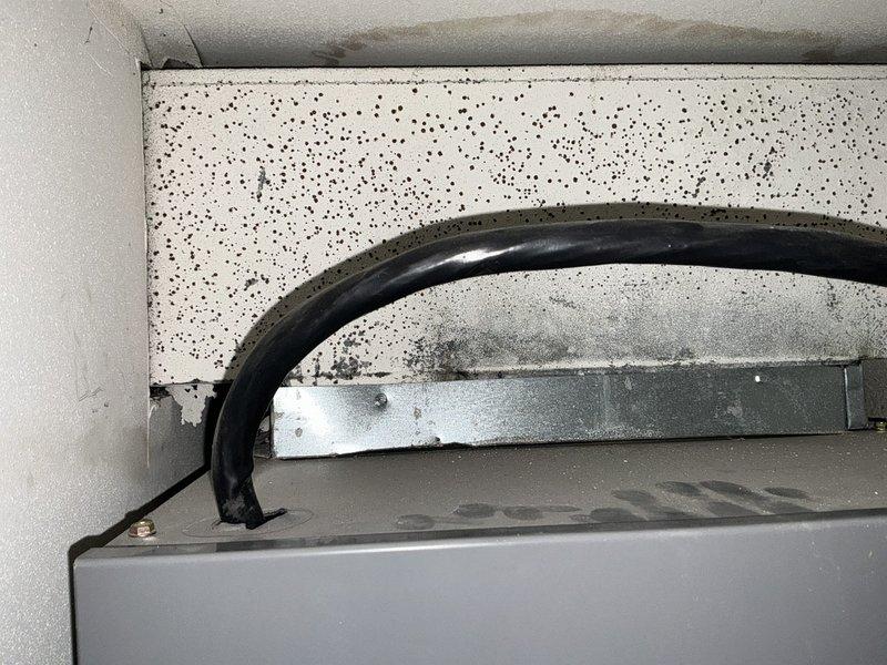 Performed assessment of existing HVAC system showing signs of age and possible moisture damage. Evaluation revealed deterioration around the unit installation point with potential mold development on surrounding ceiling/wall. Recommended full system replacement with proper drainage installation and sealing of air handler to prevent future moisture issues.