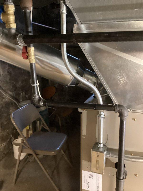 Completed installation of a new furnace unit in the utility area. Connected unit to existing ductwork and gas line, ensuring proper valve connections and secure mounting. Installed concrete floor cap around utility pipe for improved sealing and safety.