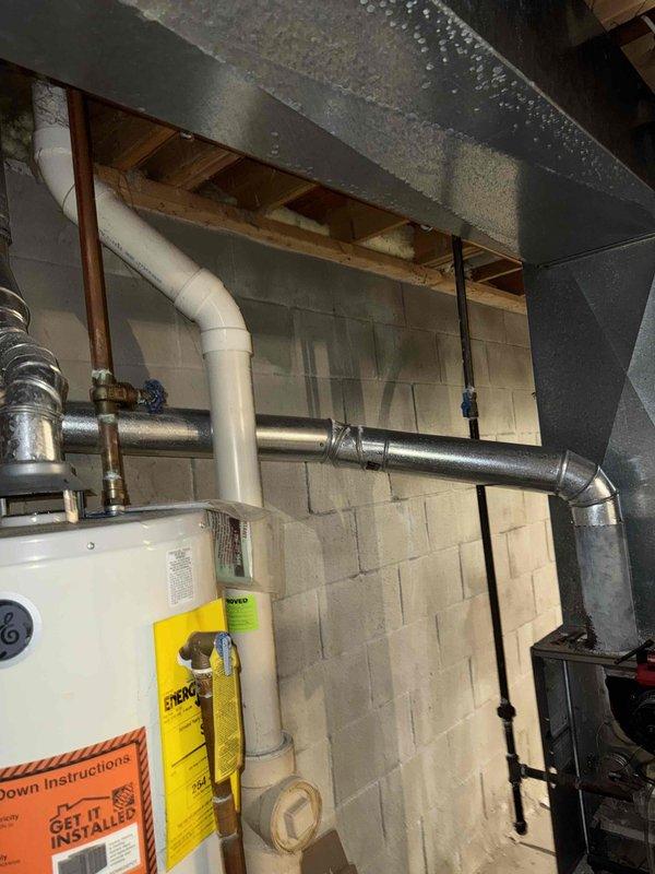 Conducted assessment of aging furnace unit showing significant dust accumulation and wear on internal components including blower motor, wiring, and gas valve assembly. Identified condensation issues on ductwork in basement utility area, indicating potential humidity control problems. Recommended complete HVAC system replacement to address efficiency concerns and prevent future moisture-related complications.