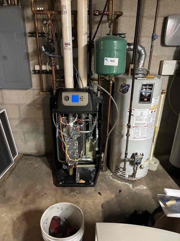 Performed comprehensive tune-up of basement HVAC system, including inspection of furnace internals and heat exchanger. Cleaned accumulated dust and debris from evaporator coil assembly to improve efficiency and airflow. Checked connections between furnace, water heater, and expansion tank to ensure proper operation of the complete heating system.