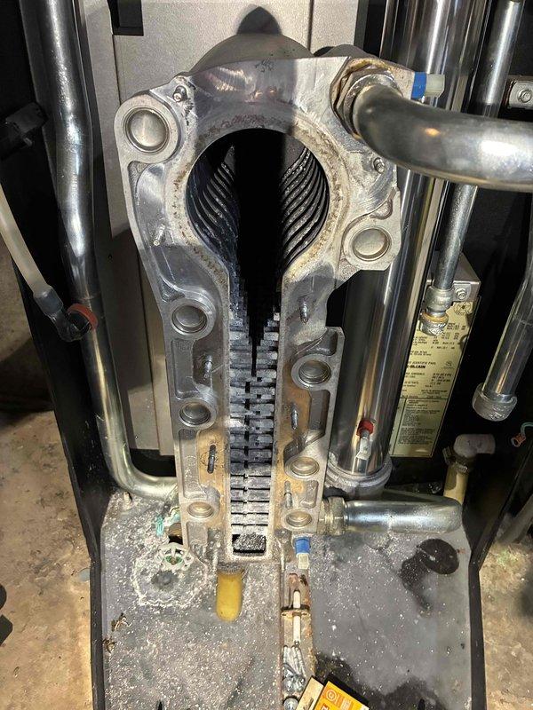 Performed comprehensive tune-up of basement HVAC system, including inspection of furnace internals and heat exchanger. Cleaned accumulated dust and debris from evaporator coil assembly to improve efficiency and airflow. Checked connections between furnace, water heater, and expansion tank to ensure proper operation of the complete heating system.