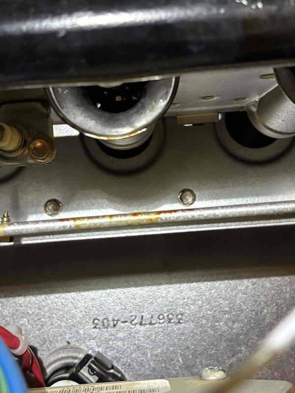 Performed tune-up service on HVAC system with inspection of heat exchanger components and refrigeration lines. Noted minor corrosion on heat exchanger tubes and identified a frozen/iced condensate trap. Cleaned corroded areas, thawed and cleared blocked condensate drain assembly, and verified proper system operation after service. System now functioning within normal parameters.