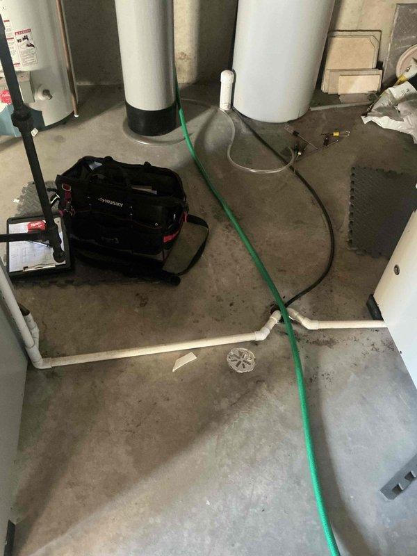 Conducted evaluation of existing HVAC system in utility room, documenting condition of ductwork and water heating equipment. Assessed metal ductwork mounting and connections for potential replacement, noting current system configuration and spatial requirements for new installation.