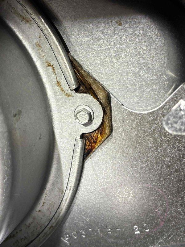 Performed inspection of mechanical equipment showing significant corrosion and wear. Identified rust formation at metal bracket connection points and deterioration around valve assembly with copper fitting. Documented condition of threaded pipe connections and wire routing for further assessment and repair planning.