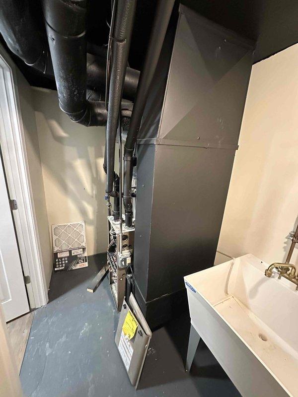 Completed comprehensive inspection of aging HVAC system located in utility closet. Assessed furnace unit with visible wear on internal components (copper tubing and wiring) and evaluated adjacent air handler with efficiency concerns. Recommended full system replacement to improve energy efficiency and reliability, with new equipment properly sized for the residence.