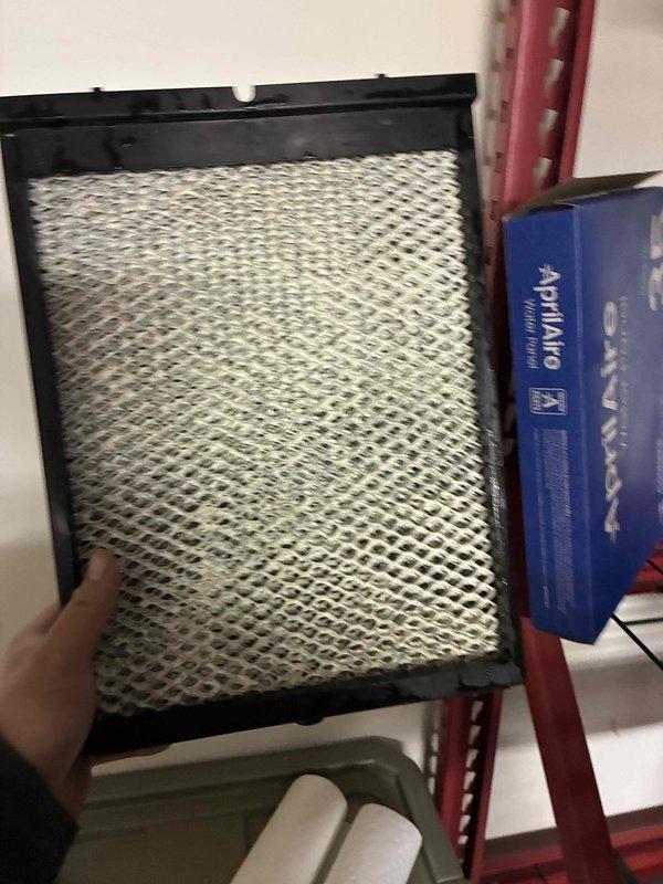 Performed indoor air quality service including inspection and replacement of AprilAire filter. Removed existing filter which showed visible contamination (green spot on metallic surface), indicating proper filtration was occurring but replacement was necessary. Installed new filter to maintain optimal IAQ and system efficiency.