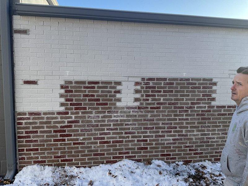 Conducted initial assessment of residential property requiring HVAC replacement. Inspected interior wall cavities with exposed framing and insulation to evaluate existing ductwork configuration and potential system integration challenges. Examined exterior building envelope to assess optimal location for outdoor unit placement, noting proper drainage considerations with existing downspout system.