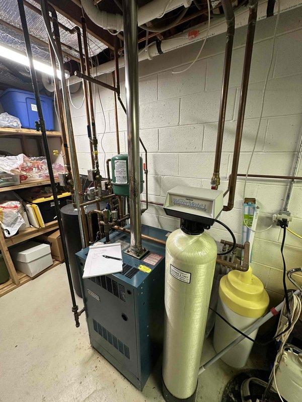 Conducted comprehensive evaluation of existing boiler system in basement utility area. Inspected copper distribution piping network and water treatment components, including WaterBoss filtration system. Documented current installation configuration and identified potential optimization opportunities for heating efficiency.