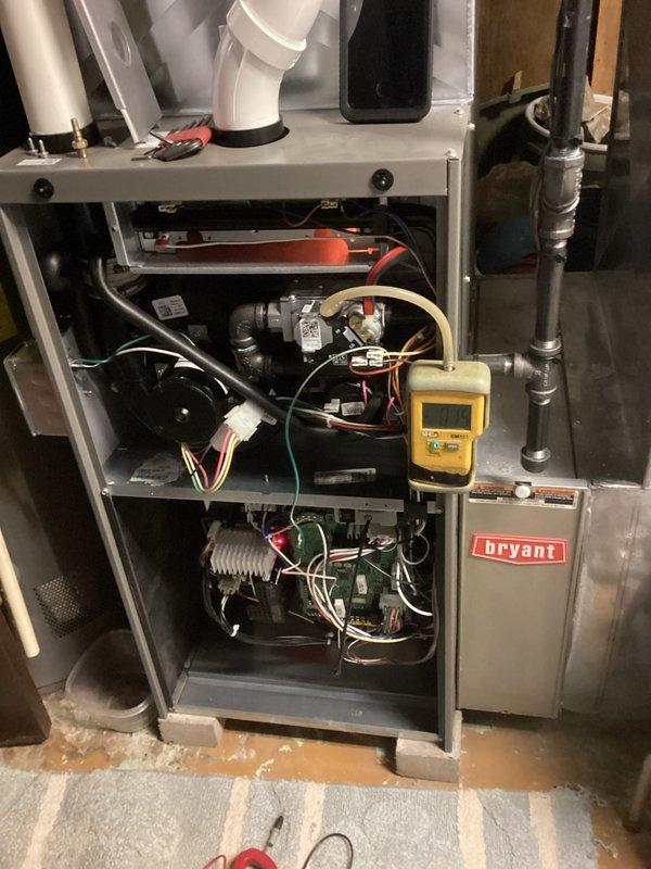 Performed scheduled tune-up on Bryant HVAC system. Removed front panel to access internal components for comprehensive inspection and testing. Utilized Testo 310 analyzer to evaluate combustion efficiency, with readings showing optimal performance (O2: 9%, CO2: 6.28%, efficiency: 93.4%). All internal components including blower motor, circuit board, and electrical connections were inspected and found to be in proper working condition.