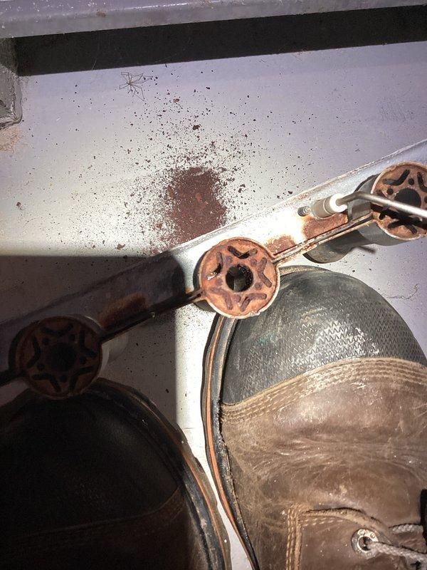 Responded to no heat call for unit under 10 years old. Upon inspection, found significant rust and debris below the furnace. Investigation revealed severely corroded copper piping in the burner assembly with active blue flames present. Cleaned accumulated rust particles from the area, replaced deteriorated copper gas line assembly, and verified proper burner operation before completing service.