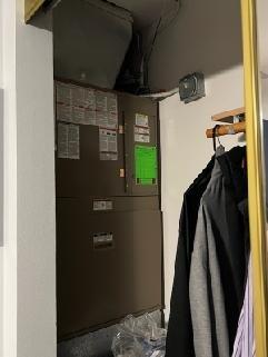 Conducted inspection of Goodman furnace system in utility closet area. Identified significant ice damming and icicle formation along roof edge, indicating potential heat loss issues. Recommended improved attic insulation and ventilation to prevent future ice dam formation that could lead to water intrusion and system inefficiency.