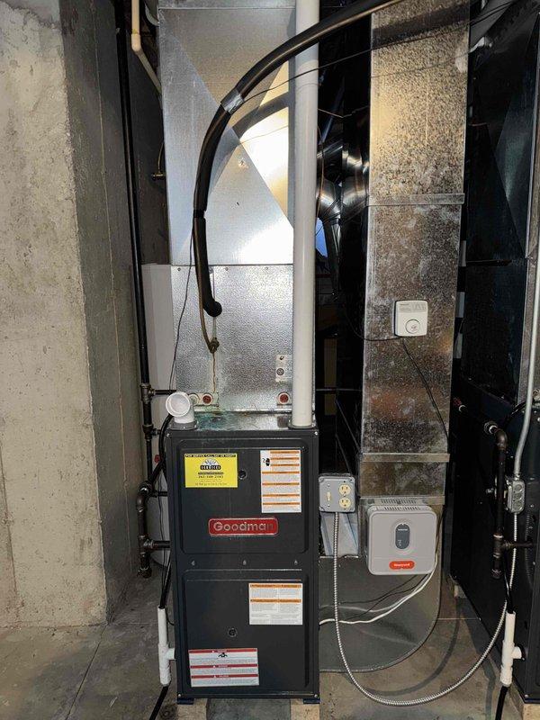 Responded to no-heat call for aging Goodman furnace system located in basement. Upon inspection, identified clogged condensate drain line and failing ignition control module causing heat failure. Cleaned drain line, replaced ignition module, and tested system through multiple heating cycles to confirm proper operation with normal flame characteristics and adequate airflow through ductwork.